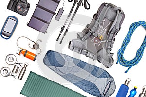 Set of tourist trekking items on white background. Top view of accessories for travel. Equipment for travel and hiking. Survival