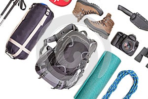 Set of tourist trekking items on white background. Top view of accessories for travel. Equipment for travel and hiking. Survival