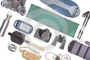 Set of tourist trekking items on white background. Top view of accessories for travel. Equipment for travel and hiking. Survival