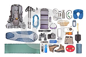 Set of tourist trekking items on white background. Top view of accessories for travel. Equipment for travel and hiking. Survival