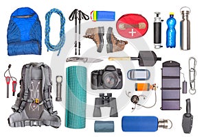 Set of tourist trekking items on white background. Top view of accessories for travel. Equipment for travel and hiking. Survival