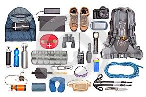 Set of tourist trekking items on white background. Top view of accessories for travel. Equipment for travel and hiking. Survival