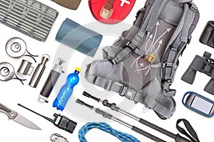 Set of tourist trekking items on white background. Top view of accessories for travel. Equipment for travel and hiking. Survival