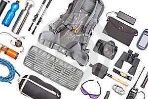 Set of tourist trekking items on white background. Top view of accessories for travel. Equipment for travel and hiking. Survival