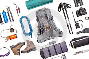 Set of tourist trekking items on white background. Top view of accessories for travel. Equipment for travel and hiking. Survival