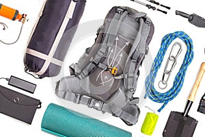 Set of tourist trekking items on white background. Top view of accessories for travel. Equipment for travel and hiking. Survival