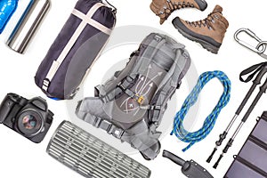 Set of tourist trekking items on white background. Top view of accessories for travel. Equipment for travel and hiking. Survival