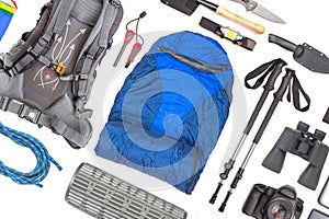 Set of tourist trekking items on white background. Top view of accessories for travel. Equipment for travel and hiking. Survival