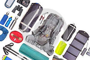 Set of tourist trekking items on white background. Top view of accessories for travel. Equipment for travel and hiking. Survival