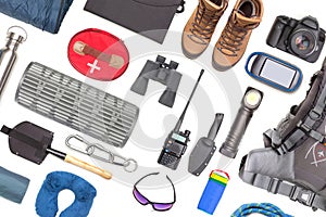 Set of tourist trekking items on white background. Top view of accessories for travel. Equipment for travel and hiking. Survival