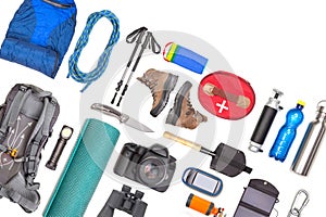 Set of tourist trekking items on white background. Top view of accessories for travel. Equipment for travel and hiking. Survival