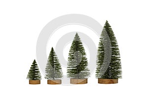 Set of toy Christmas trees on wooden stands in a row, isolated on white.