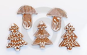 Ornate Christmas gingerbreads in tree or mushroom shape on white background
