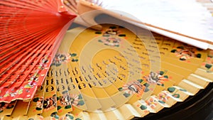 Set of traditional hand fans decorated with flowers gyrating