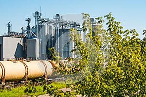 Set of train tanks next to plant for grain processing