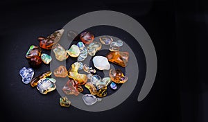 Set of transparent sparkling opals collage on black background