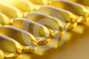 Set of transparent yellow capsules with omega-3 on yellow backlit background.