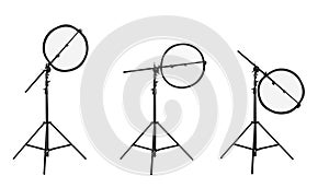 Set of tripods with reflectors on white background. Professional photographer`s equipment