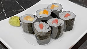 Set of tuna and salmon sushi maki gunkan roll, serving with wasabi on white plate. Japanese food restaurant. Traditional Japanese