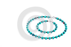 Set of turquoise necklace and bracelet isolated on white background. Female accessories, decorative ornaments and jewelry.