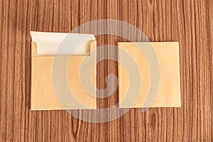 Set of two Brown envelope front and back isolated on wooden table hardwood floor background. Business cards blank. Mockup. Top