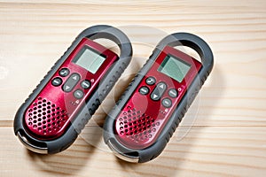 Set of two intercoms of red color on a wooden background