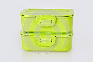 Set of two similar green plastic food storage containers