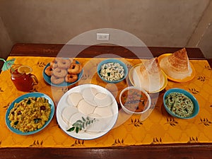 A set-up of South Indian food. Dosa, idli and sambara.