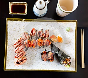 Set of uramaki, nigiri and temaki served with soya sauce photo