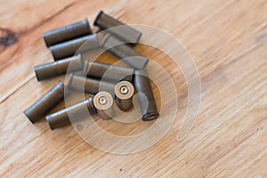 A set used to of old bullets and cartridges on wood background