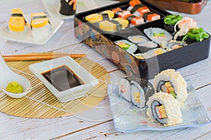 variety sushi, Tamagoyaki, crabsticks sushi and maki in bento box served with soy sauce and wasabi. Delicious japanese food