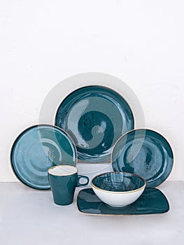 Set of various blue plates on table. Collection of blue dishware of different sizes on table