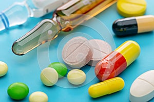 A set of various drugs for therapy. On blue background, copy space