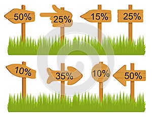 Set of various empty wooden sign boards, wood arrow sign on green grass. Retro, old or vintage signs point on percent.