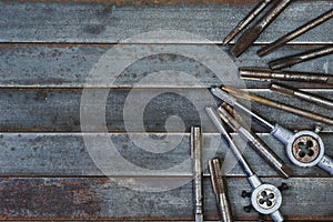 Set of various equipment for threading with copy space, carpenter tool old rusty metal background.