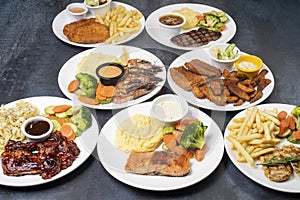 Set of various food dishes shot on dark background