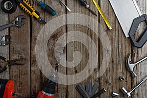 Set of various hand tools on rustic wooden background. View from above. Flat lay. Space for text. Concept of professional home