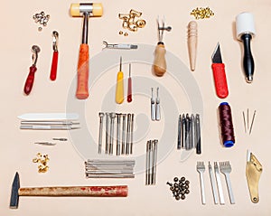 Set of various leathercraft tools on leather