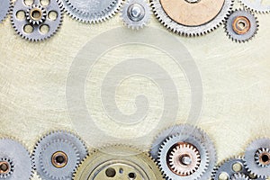 Set of various mechanical gears on brushed metal background