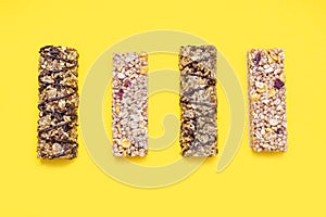 Set of various muesli bars on a yellow background