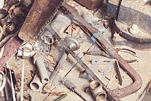 Set of various old equipment, rusty instruments and tools for carpenter work on wooden table. Toned