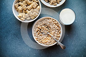 Set of various tasty breakfast cereals on light grey table, flat lay top view