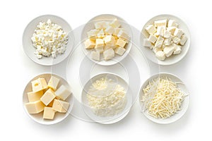Set of various types of cheese in white bowl, top view
