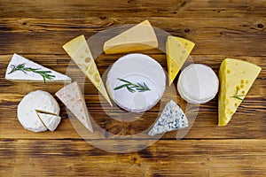 Set of various types of cheese on wooden table. Top view