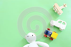 Set of various vintage old toys over green pastel wooden background. Top view image