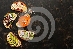 Set of vegan sandwiches with vegetables and fruits on a dark rustic background. Top view, flat lay. Vegetarian snack