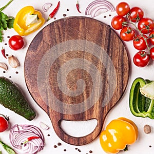 Set of vegetables and herbs around wooden cutting board. Social media or blog background