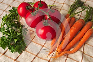 Set of vegetables seen from above carrots, some tomatoes, some parsley branches