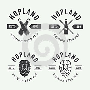 Set of vintage beer and pub logos, labels and emblems with bottles, hops, and wheat