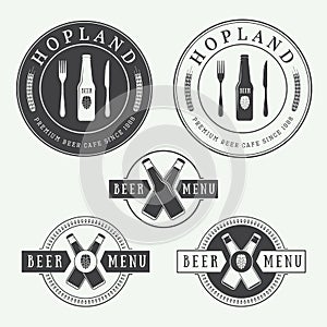 Set of vintage beer and pub logos, labels and emblems with bottles, hops, and wheat